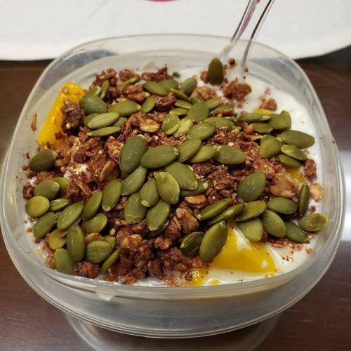 high protein breakfast with greek yogurt, pumpkin seeds, protein granola and mango