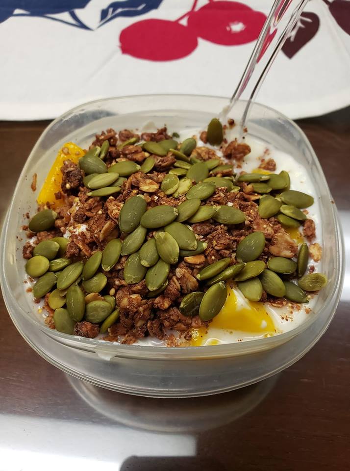 high protein breakfast with greek yogurt, pumpkin seeds, protein granola and mango