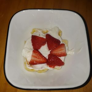 sliced strawberries on top of healthier banana splits