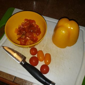 chopped tomatoes and pepper on cutting board